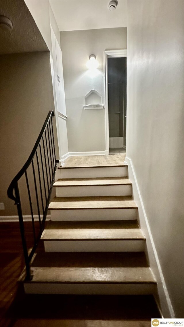 staircase featuring hardwood / wood-style flooring