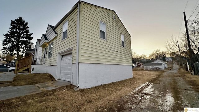 property exterior at dusk with a garage