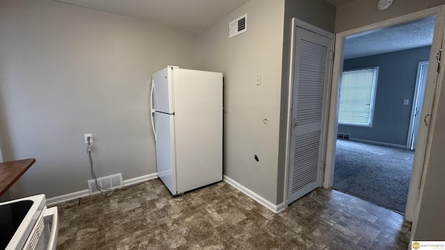 kitchen with white appliances and a textured ceiling