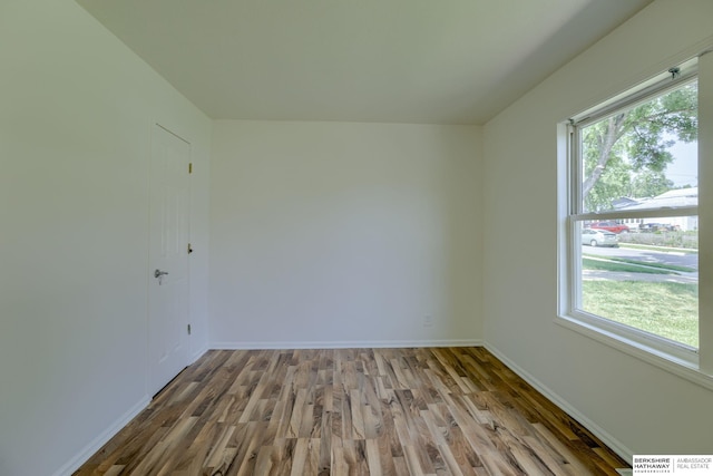 7336 S 71st Ave, Omaha, NE 68128 - empty room with wood finished floors and plenty of natural light
