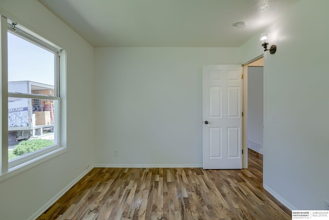 7336 S 71st Ave, Omaha, NE 68128 - spare room with wood finished floors and a smoke detector