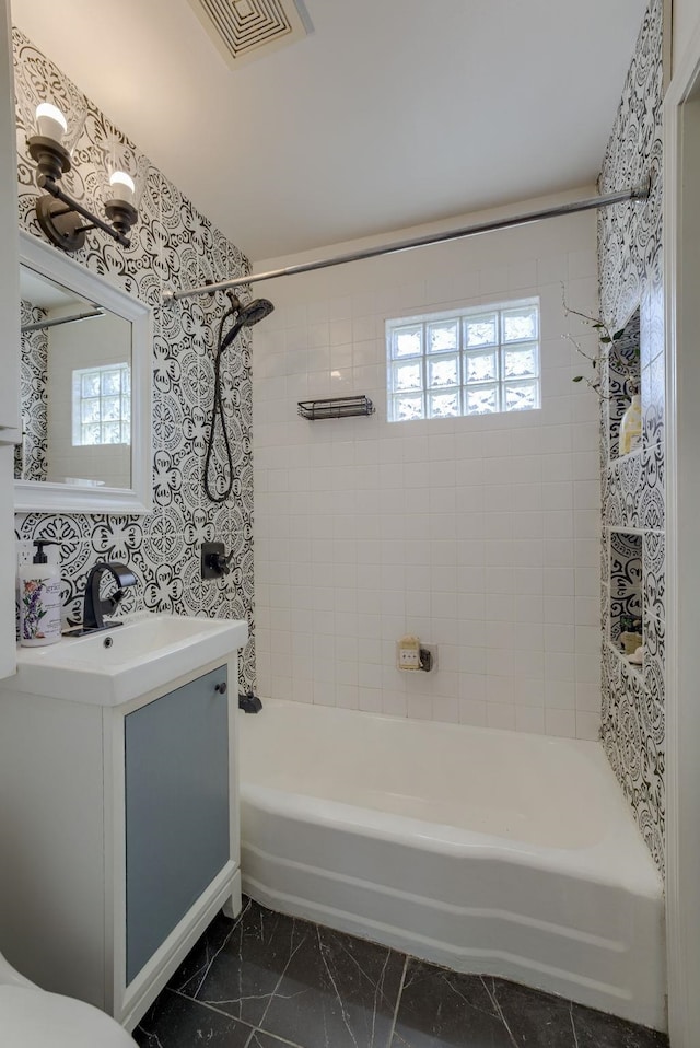7336 S 71st Ave, Omaha, NE 68128 - full bath featuring bathtub / shower combination, vanity, plenty of natural light, and marble finish flooring