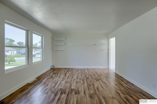 7336 S 71st Ave, Omaha, NE 68128 - empty room featuring wood finished floors and a textured ceiling