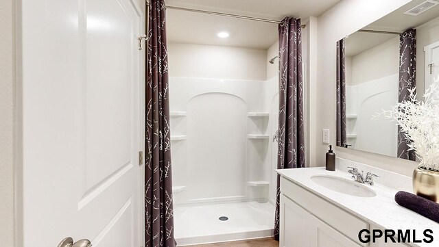 bathroom with vanity and curtained shower