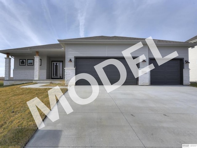 view of front of house featuring a garage and a front lawn