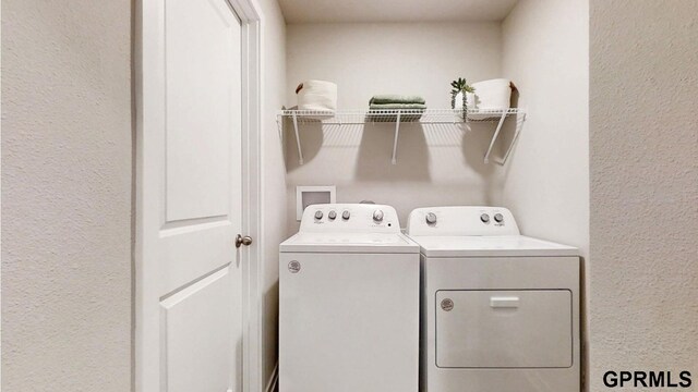 laundry area with separate washer and dryer