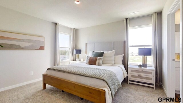 carpeted bedroom featuring multiple windows