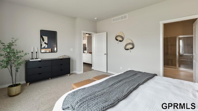 bedroom featuring ensuite bathroom and carpet