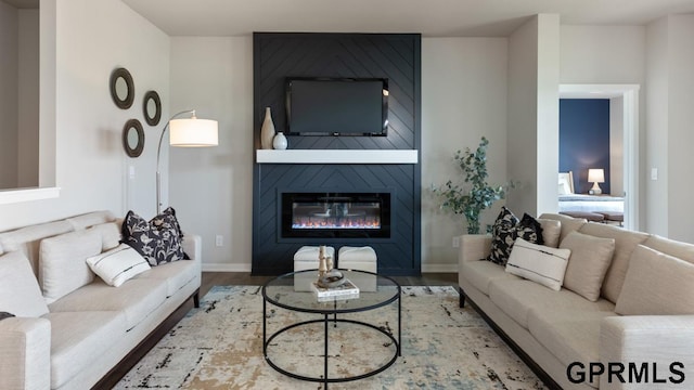 living room featuring wood-type flooring and a fireplace