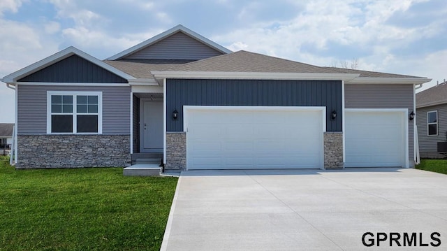 craftsman inspired home featuring a garage and a front lawn