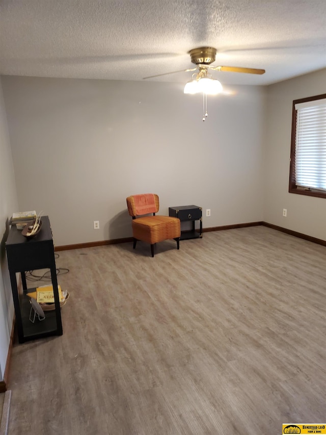 unfurnished room with hardwood / wood-style floors, a textured ceiling, and ceiling fan