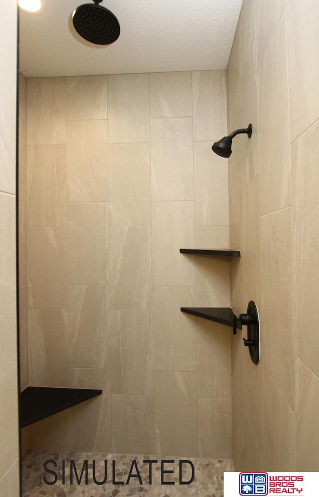 bathroom with a tile shower