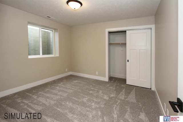 unfurnished bedroom featuring a closet, carpet flooring, and a textured ceiling