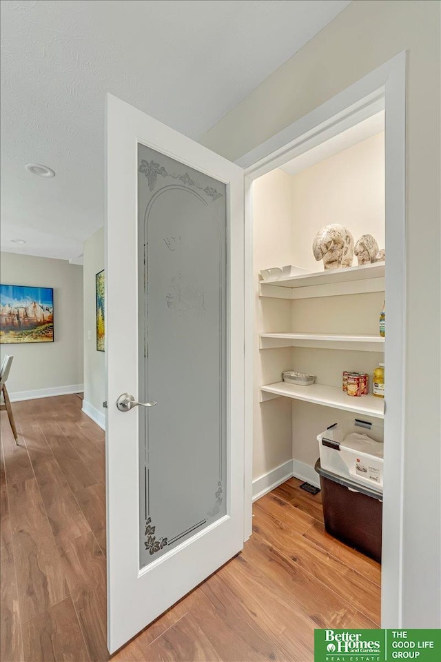 bathroom featuring hardwood / wood-style floors and a textured ceiling