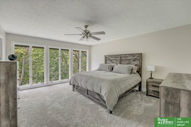 carpeted bedroom featuring a textured ceiling and ceiling fan