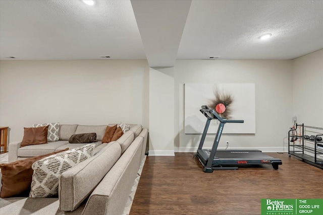 workout area featuring a textured ceiling and wood-type flooring