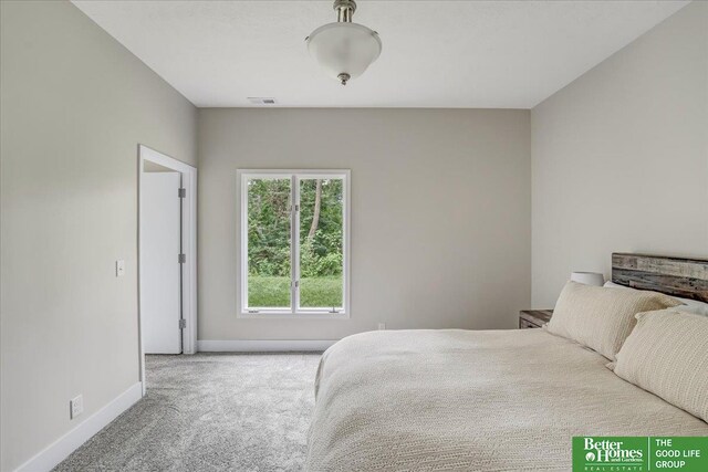 bedroom featuring light carpet