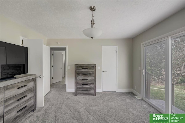 unfurnished bedroom with light carpet and a textured ceiling