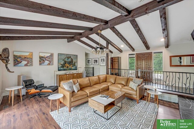 living room featuring a chandelier, lofted ceiling with beams, and hardwood / wood-style flooring