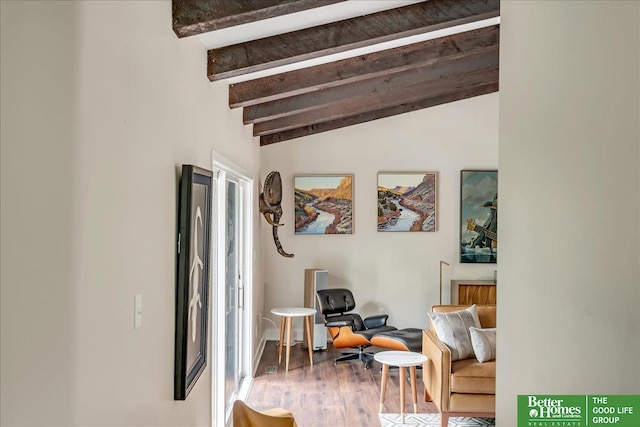 living area featuring lofted ceiling with beams and wood-type flooring