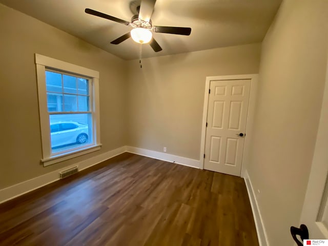 unfurnished room featuring ceiling fan and dark hardwood / wood-style flooring