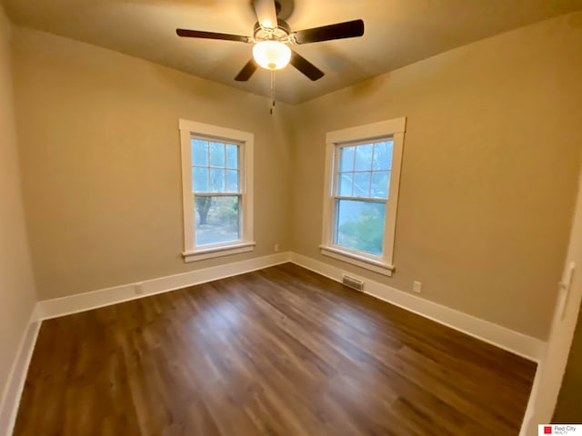 unfurnished room featuring ceiling fan and dark hardwood / wood-style flooring