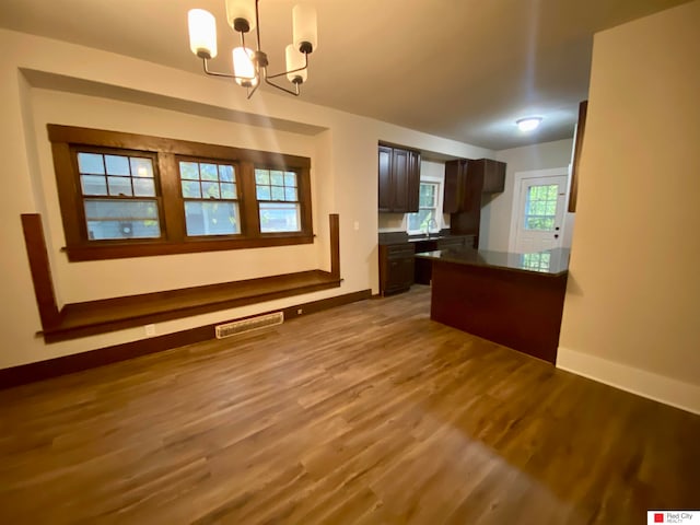 interior space with wood-type flooring, sink, and a chandelier