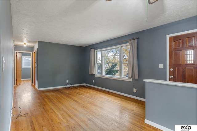 interior space featuring a textured ceiling and light hardwood / wood-style floors