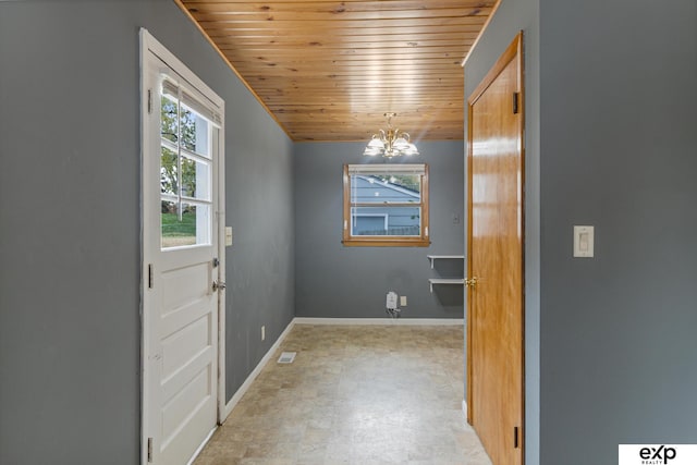 doorway with wood ceiling and an inviting chandelier