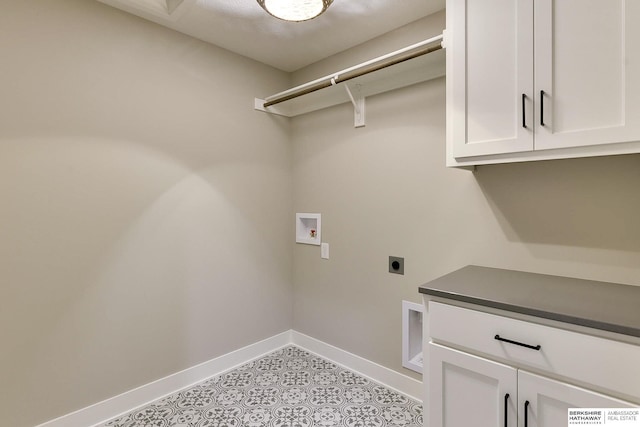 laundry area with cabinets, hookup for an electric dryer, and hookup for a washing machine