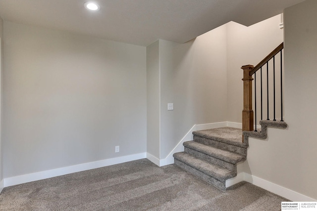 staircase featuring carpet flooring