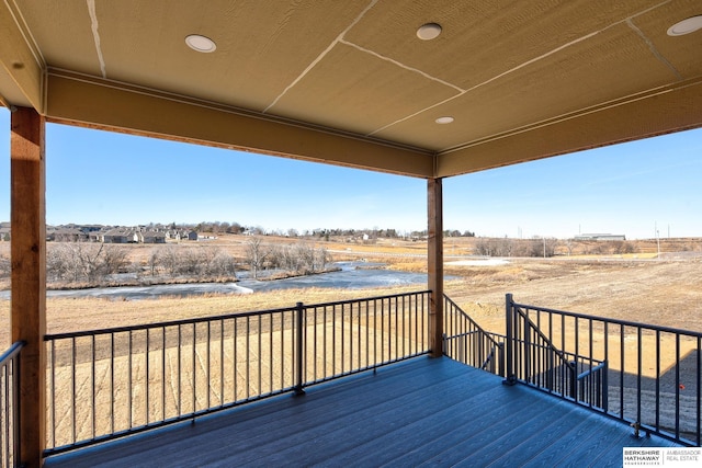 wooden deck featuring a rural view