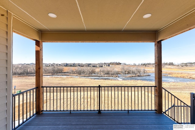 wooden deck featuring a rural view