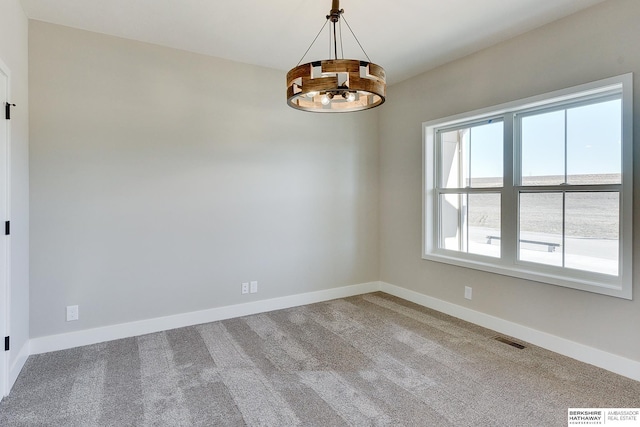 unfurnished room with light carpet and a notable chandelier