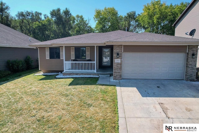 single story home featuring a porch, a front lawn, and a garage