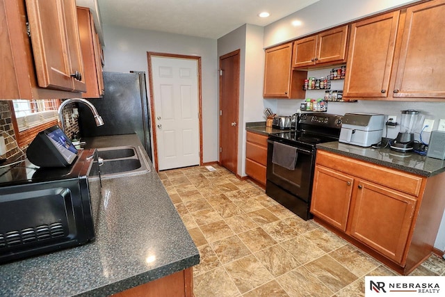 kitchen with tasteful backsplash, black appliances, and sink