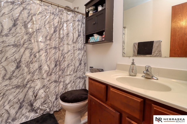 bathroom featuring toilet, vanity, and tile patterned floors