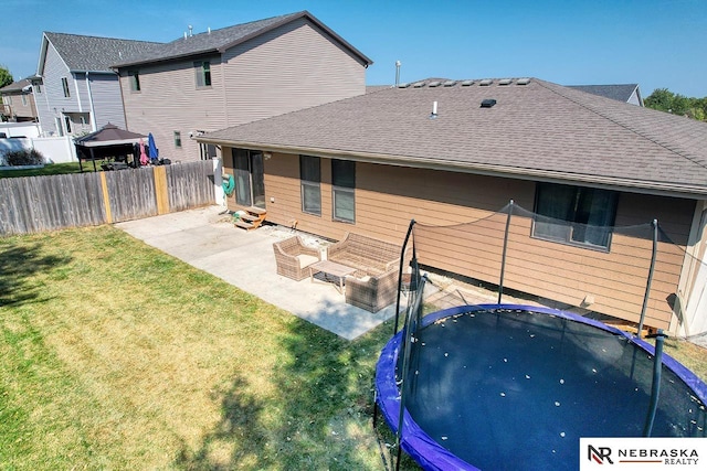 back of property with cooling unit, a yard, a trampoline, and a patio area