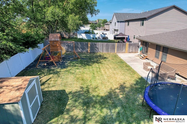 view of yard featuring a storage shed, a trampoline, a patio, and a playground