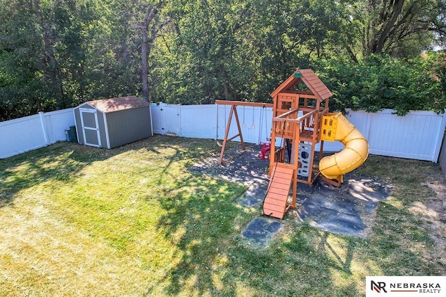 view of yard with a storage shed and a playground