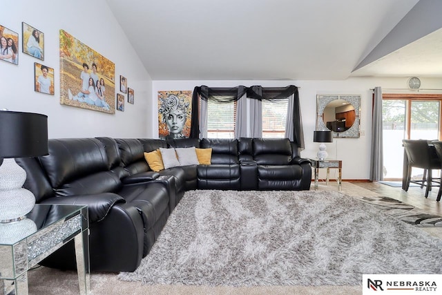 living room featuring lofted ceiling and carpet floors