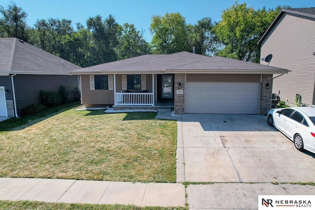 ranch-style home with covered porch, a garage, and a front lawn