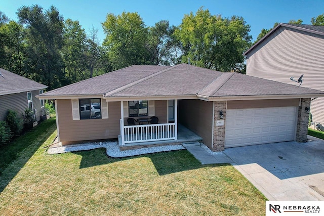 single story home featuring a garage, a front lawn, and a porch