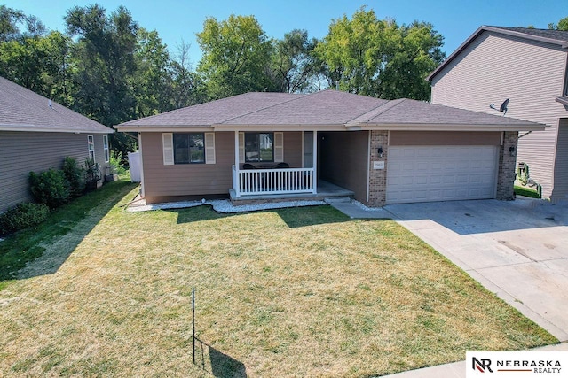 single story home with covered porch, a garage, and a front lawn