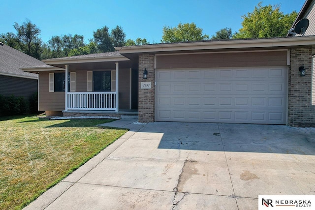 ranch-style house featuring a porch, a front lawn, and a garage