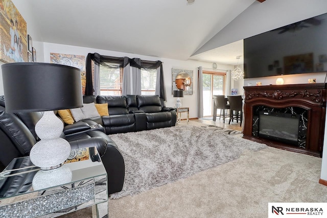 carpeted living room featuring lofted ceiling