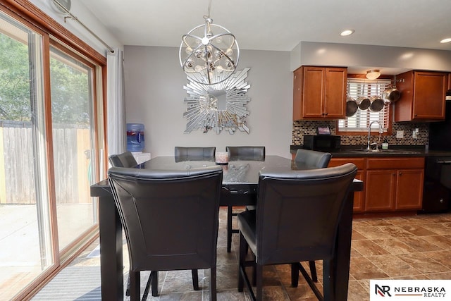 dining room featuring sink and a notable chandelier