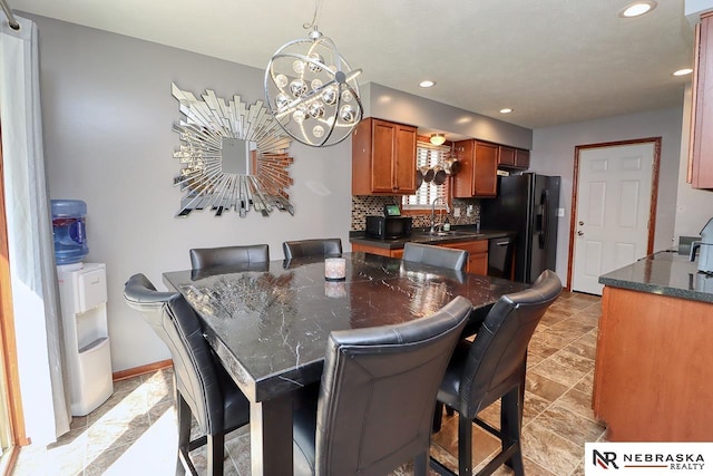 dining space featuring a notable chandelier and sink