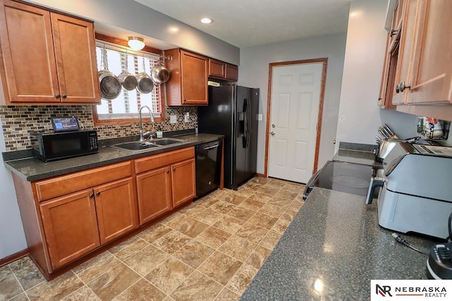 kitchen featuring sink, black appliances, and tasteful backsplash