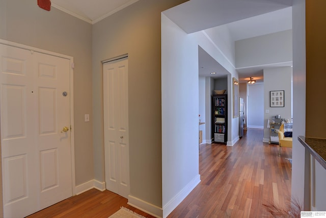 entryway featuring crown molding and hardwood / wood-style flooring